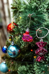 Christmas toys on an artificial Christmas tree close-up