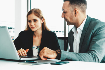 Businessman executive is in meeting discussion with a businesswoman worker in modern workplace office. People corporate business team concept. uds