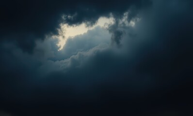 Dramatic dark clouds with light peeking through