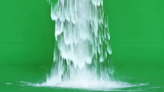 Water Fountain Cascade: A mesmerizing close-up of a flowing water fountain, with the water cascading down in a dynamic and refreshing display against a vibrant green screen.  