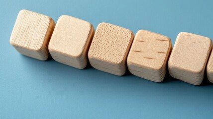 Wooden cubes on blue surface, smooth textures