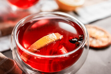 red tea into a glass cup, hibiscus, tea with red berries, vitamin drink, winter tea for colds, lemon, red currant, black currant, raspberry, honey, cinnamon, anise