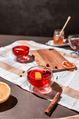 red tea into a glass cup, hibiscus, tea with red berries, vitamin drink, winter tea for colds, lemon, red currant, black currant, raspberry, honey, cinnamon, anise