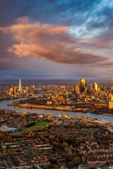 The skyline of London, England, during a beautiful sunrise with golden colours and cloudscape