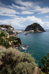 village Sant'Angelo, giant green rock in blue sea near Ischia Island, Italy