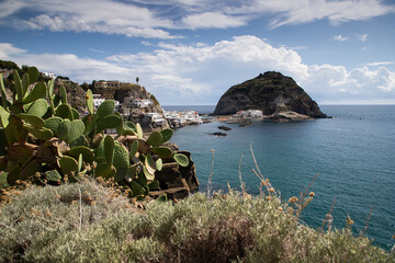 Naklejka premium village Sant'Angelo, giant green rock in blue sea near Ischia Island, Italy