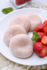 Delicious mochi and strawberries on table, closeup