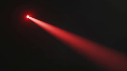 Red light beam on dark background. Spotlight animation. Bright ray for design, presentation, intro, outro. Steady shot.