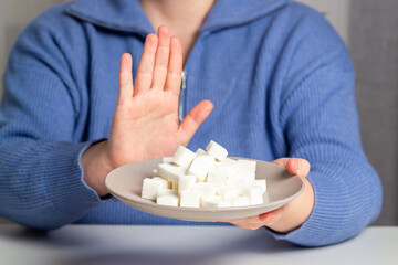 Woman decided to stop eat sugar for health and weight loss. Hand stop sign. Choosing healthy lifestyle. Long living concept.