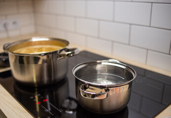 iron pots on stove, modern kitchen utensils