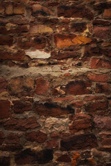 vertical background of ancient medieval weathered prague wall made of red brick and cement. creative element of historical european architecture