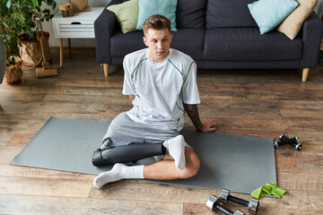 Young man with prosthetic leg working out at home in a comfortable living space