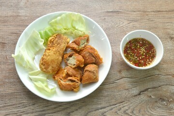 fried slice Vietnamese chicken sausage recipe with cabbage on plate dipping spicy sauce