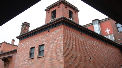Obraz premium old weathered red brick wall with varying shades of red, wide panorama of masonry, urban, panorama