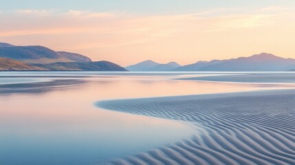 Obraz premium A serene seaside shot with soft ripples and a sandy beach, radiating warmth and tranquility under a pastel sky