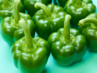 Beautiful sweet bell peppers over emerald background