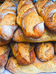 A close-up of a stack of freshly baked bread baguettes.