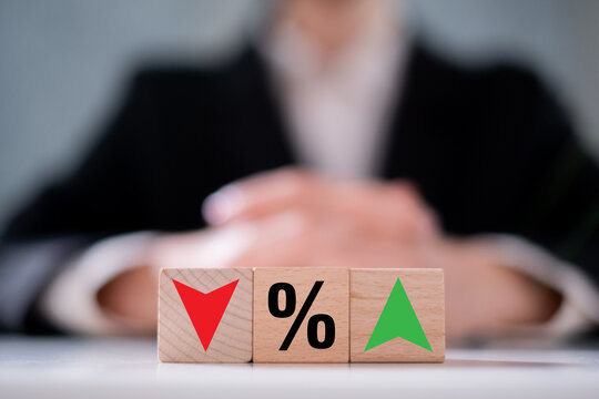 Income debt interest percent inflation with increase and decrease icon on wooden block finance business economy investment concept