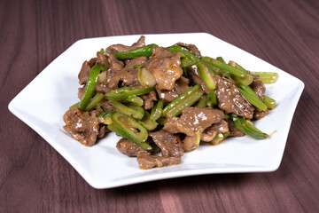 Celery stir-fried beef on a white plate