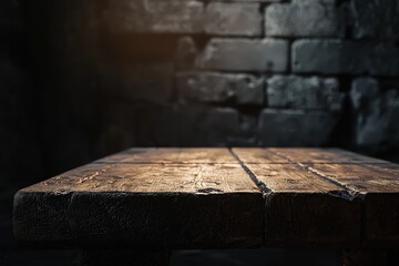 Old wood table with blurred concrete block wall in dark room background