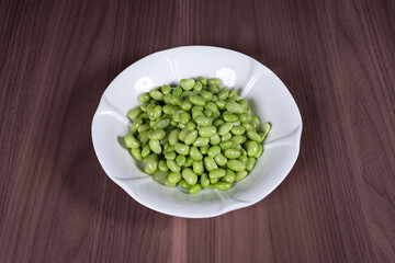 Boiled edamame on a white plate