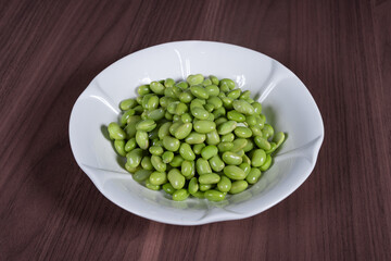 Boiled edamame on a white plate