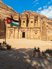 Petra, Jordan : The Jordanian flag flies in front of the ancient Monastery building in Petra (Ad Deir) (one of the Seven Wonders of the World) historical place