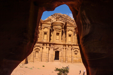 Petra, Jordan : ancient Monastery building in Petra (Ad Deir) from a cave // one of the Seven Wonders of the World (historical place in Arab countries)