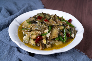 Vegetable fried eggplant on a white plate on the table