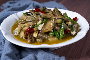 Vegetable fried eggplant on a white plate on the table