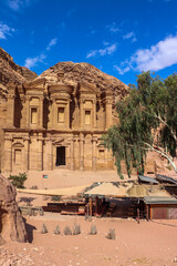 Petra, Jordan : ancient Monastery building in Petra (Ad Deir) with trees / one of the Seven Wonders of the World (historical place in Arab countries)