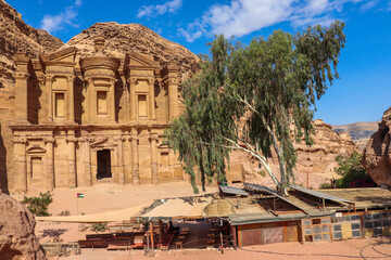 Petra, Jordan : ancient Monastery building in Petra (Ad Deir) with trees / one of the Seven Wonders of the World (historical place in Arab countries)