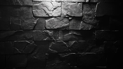 Dark gray stone wall texture with light spotlight.