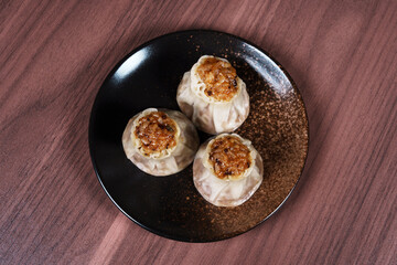 A breakfast treat on a plate with mushrooms and chicken