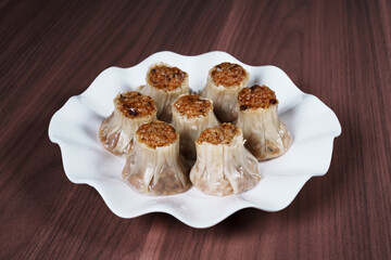 A breakfast treat on a plate with mushrooms and chicken