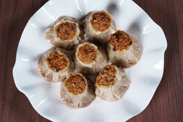 A breakfast treat on a plate with mushrooms and chicken