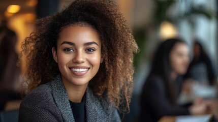 A Young Woman With Curly Hair Smiles Confidently