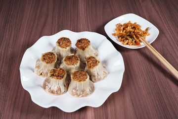 A breakfast treat on a plate with mushrooms and chicken