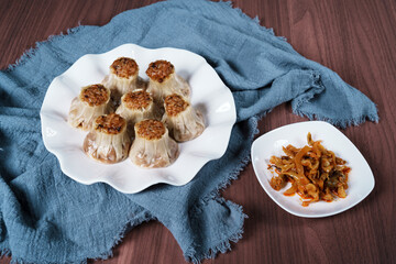 A breakfast treat on a plate with mushrooms and chicken