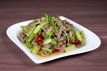 Celery stir-fried beef on a white plate