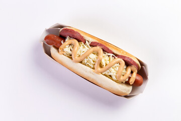Appetizing hot dog in packaging on a light background.