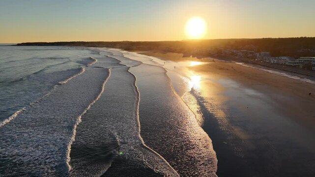 Aerial footage of the Long Sands Beach at sunset in Tynemouth town in Tyne and Wear, England, UK