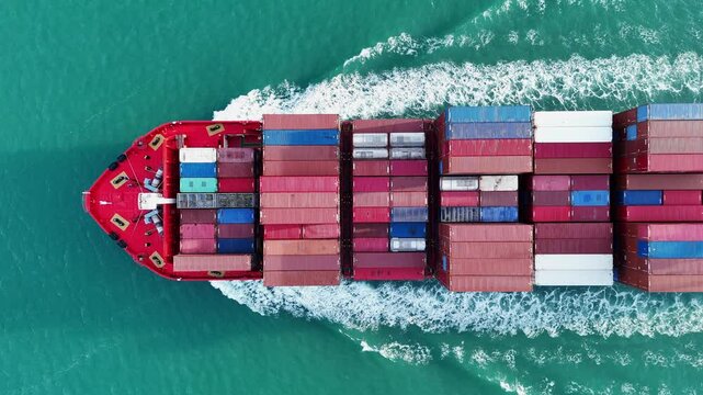 Aerial top view of cargo ship carrying container and running for export cargo yard port to custom ocean concept technology transportation , customs clearance