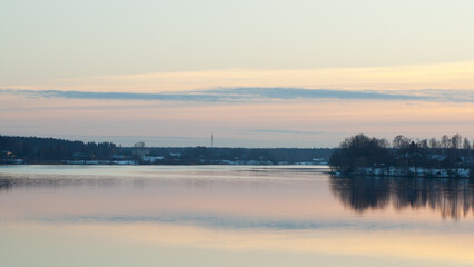 Obraz premium The photo shows a sunset on the river in winter