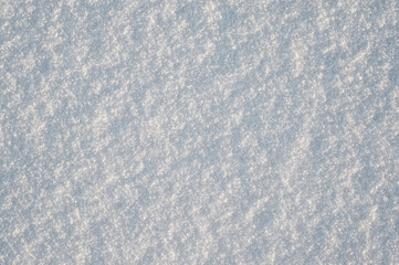 gray background, photo shows texture of white snow close-up
