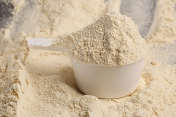 spoon with protein powder on light backgroun