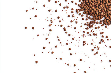 Fototapeta premium Brown coffee granules are spilled across a clean white surface, forming an appealing pattern that highlights the rich texture and color of the coffee
