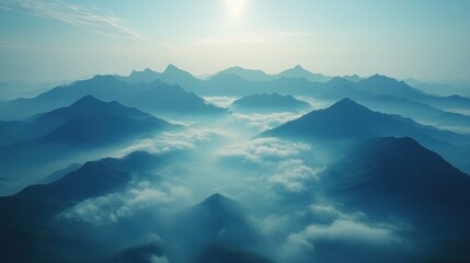 A serene mountain landscape shrouded in mist, illuminated by soft sunlight.