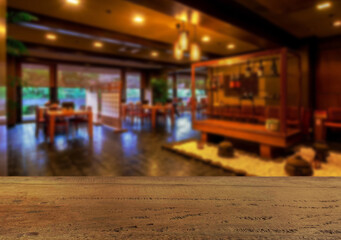 Wooden table top on blur night restaurant or cafe background.For montage product display or design key visual layout.View of copy space.