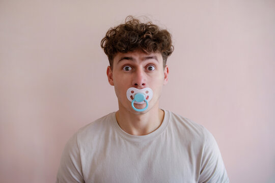 Man with a pacifier in his mouth.